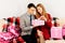 young couple  man and woman celebrate Valentine\'s Day at home and give each other gifts