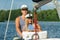 Young couple man and woman sailors at the helm of