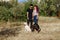 Young couple man and woman walk with their dogs in the park