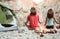 Young couple meditating together while camping on mountains - Healthy people training mind with meditate exercises