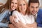 Young couple with mother-in-law at home weekend family portrait