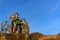 Young couple on a motorcycle on on rocky ground. Happy guy and girl travelling on a motorbike