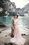 Young couple near lake Karersee, Italy. Holding hands at the stone at lake