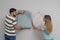 Young couple with new wall papers on light grey