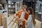 Young couple observing wicker chair garden furniture at shop