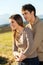 Young couple outdoors in rural field.