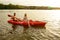 Young Couple Paddling Kayak on Beautiful River or Lake in the Evening at Sunset