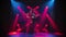 Young couple passionately dancing tango in a dark room with smoke and red spotlights in slow motion.