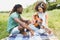 Young couple on a picnic playing guitar