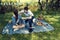 Young couple on a picnic sitting on a blanket The man cover her shoulders with blue scarf