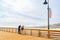 Young couple on the pier enjoying view. Pismo Beach pier, California Central Coast