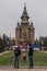 Young couple playing with a child in front of Orthodox Cathedral in Timisoara