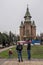 Young couple playing with a child in front of Orthodox Cathedral in Timisoara