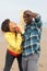 Young Couple Playing Cricket On Beach Holiday