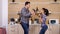 Young couple playing with kitchen tools while dinner get`s ready