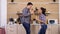 Young couple playing with kitchen tools while dinner get`s ready