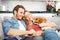 Young Couple Playing With Pet Dog At Home