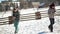 Young Couple is Playing Snowball Fight. A Man and a Woman is Having Fun Outside in Winter. Contryside Background.