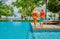 Young couple by poolside. Resort swimming pool at Seychelles