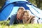 Young couple pose outside of tent