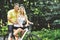 Young couple posing near a bycicle in a summer park