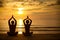 Young couple practicing yoga on beach at sunset