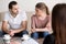 Young couple at psychologist, looking at each other with hate