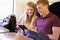 Young Couple Reading A Book On Train Journey