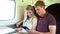 Young Couple Reading E Book On Train Journey