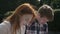 Young couple reading in park