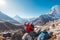 Young couple rejoicing on Everest Base Camp trekking route near Dughla 4620m. Backpackers left Backpacks and trekking poles and