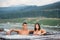 Young couple relaxing enjoying jacuzzi hot tub bubble bath outdoors on romantic vacation