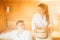 Young couple relaxing inside spa sauna room.Romantic newlyweds enjoying honeymoon vacation day doing body treatment in luxury