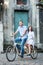 Young couple on retro tandem bicycle at the street city