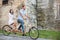 Young couple on retro tandem bicycle at the street city