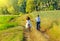 Young couple ride bicycles in the meadow