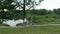 A young couple rides a tandem two-seater bike along the riverbank