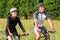 Young Couple Riding Bicycle In Meadow