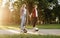 Young couple riding on gyroboard in park at sunset