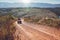 Young couple riding quad bike on country road