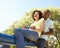 Young Couple Riding On SeeSaw In Park