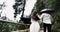 Young couple in the romantic trip running from the wooden bridge in the middle of amazing landscape with big mountains