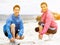 Young couple of runners tying shoelace at the seaside