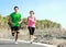 Young couple running together on jogging track