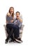 Young couple seated in an armchair pointing at the camera and la