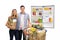 Young couple with a shopping cart and fridge with food