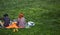 A young couple shot from behind relaxing on the grass