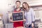 Young couple shows a board with dinner invitation