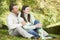 Young couple sitting in autumn woods