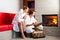 Young couple sitting in bathrobe for fire